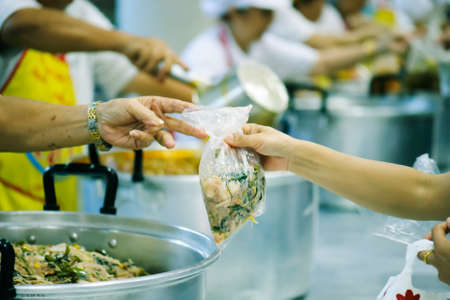 Hands-on food of the hungry is the hope of poverty : concept of homelessnessの写真素材