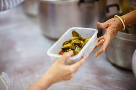 Volunteers provide food for beggars: Concepts Feeding and help