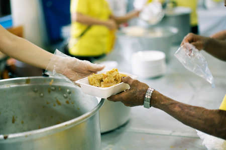 Charity food is the hope of the poor who have no money: concept of begging foodの写真素材