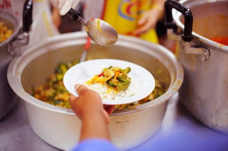 Volunteer to Feed the Hungry in Society: The Concept of Donating Food to the Poor in Societyの写真素材