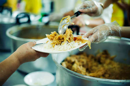 Volunteer to Feed the Hungry in Society: The Concept of Donating Food to the Poor in Societyの写真素材