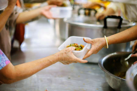 Volunteer to Feed the Hungry in Society: The Concept of Donating Food to the Poor in Societyの写真素材