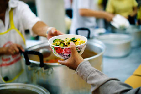 Caring for fellow human beings in society by giving food, Giving Without Hope : The Concept of Poor Careの写真素材