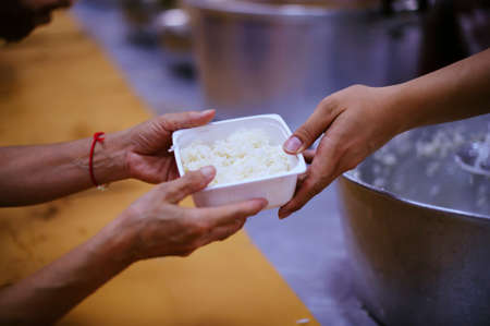 The hands of beggars receive donated food as a share in society : the concept of hunger