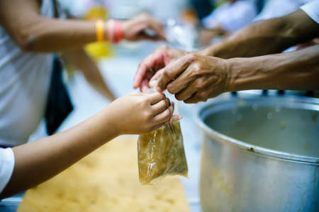 Hand-feeding to the needy in society : concept of food sharingの写真素材