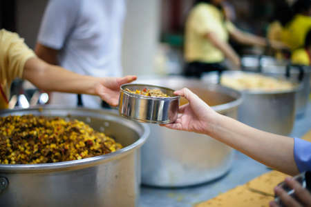 Hand-feeding to the needy in society : concept of food sharingの写真素材