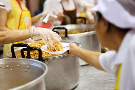 Hands of the poor are waiting for food donations to alleviate hunger : concept of feeding
