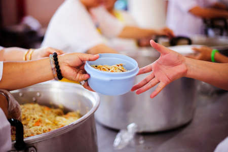 The concept of food sharing Help solve Hunger for the homelessの写真素材