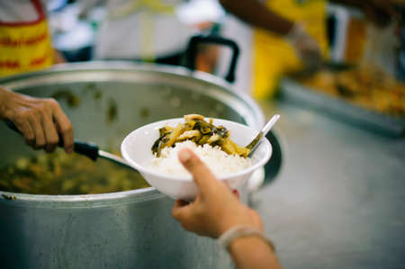 The concept of food sharing Help solve Hunger for the homelessの写真素材