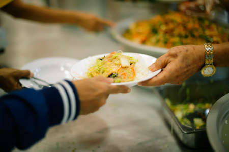 Feeding Food To Poor, Using leftovers to feed the hungry : concept serving free food to the poor
