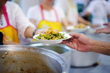 Food sharing in human societies can help homeless people, beggars.の写真素材