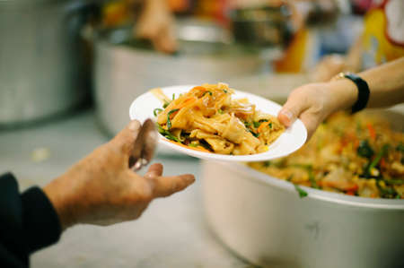 Providing food to the poor is helping sharing from fellow humans together : Concept of famine and social inequalityの写真素材