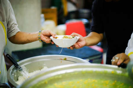 Providing food to the poor is helping sharing from fellow humans together : Concept of famine and social inequalityの写真素材
