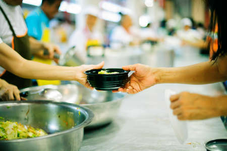 Providing food to the poor is helping sharing from fellow humans together : Concept of famine and social inequalityの写真素材