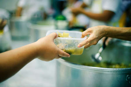Food sharing in human societies can help homeless people, beggars.の写真素材