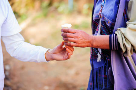 Donating food from the concern of human friends to the poor.の写真素材