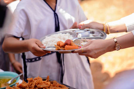 Philanthropists donate food to the poor, share food, help each other in society.