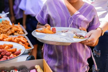 Philanthropists donate food to the poor, share food, help each other in society.の写真素材