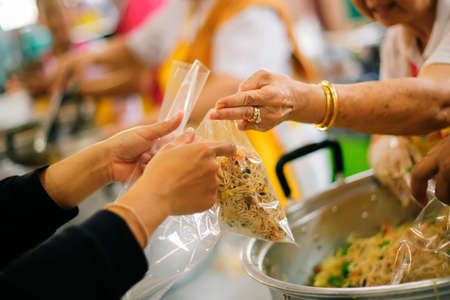 Share food for homeless hungry people to alleviate hunger food : the concept of donating aidの写真素材