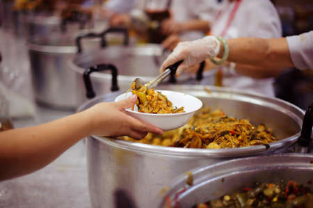 Volunteers have been feeding the homeless, They reach out with love and concern.の写真素材