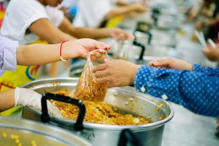 Free food distribution is social activity for helping the homeless people by giving them food.の写真素材