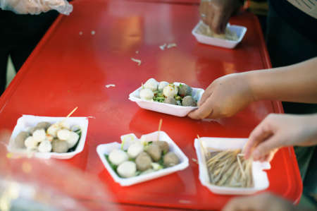 Food donation: The hands of the hungry are receiving food from the service provider.の写真素材