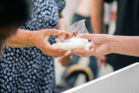 Share food from hand to hand with donations.の写真素材