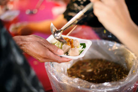 Food support: People are handing over food from volunteers with philanthropists to support cooking.の写真素材