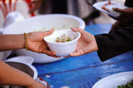 Share food from hand to hand with donations.の写真素材