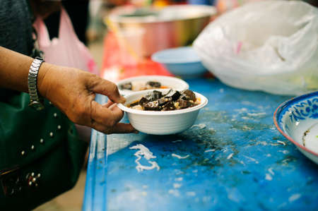 Concept of poverty: giving food to beggars with kindnessの写真素材