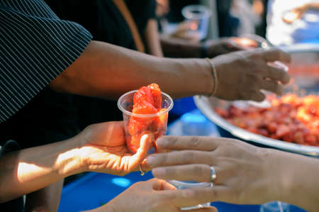 Concept of poverty: giving food to beggars with kindnessの写真素材