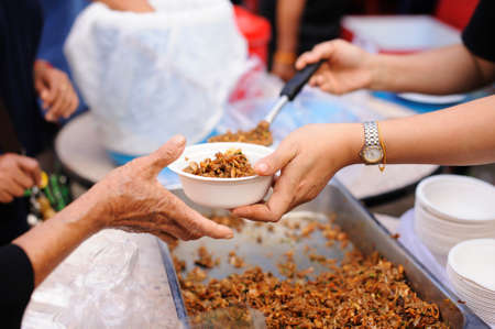 Concept of poverty: giving food to beggars with kindness