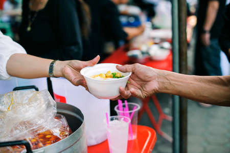 Concept of poverty: giving food to beggars with kindness