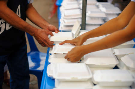 Starvation concept : Rich people give food to the poor.