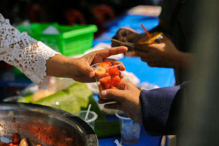 feeding to hand the poor helping  beggar in social. poverty concept