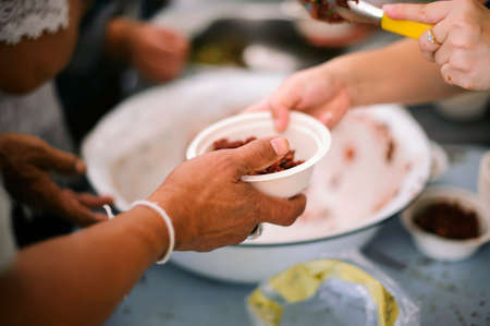 Concept of food sharing for the poor to alleviate hunger : Social Problems of Poverty Helped by Feeding : Donate food to people in society : Homeless Concepts and Povertyの写真素材