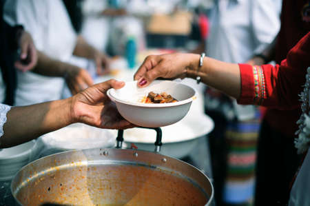 Charity food is the hope of the poor who have no money: concept of begging food : Volunteers Share Food to the Poor to Relieve Hungerの写真素材