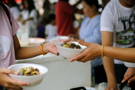 Social Problems of Poverty Helped by Feeding : Volunteer to Feed the Hungry in Society: The Concept of Donating Food to the Poor in Societyの写真素材