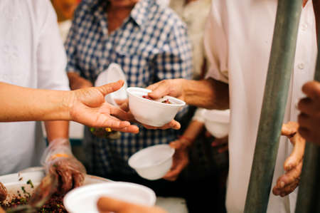 Charity food is the hope of the poor who have no money: concept of begging food : Volunteers Share Food to the Poor to Relieve Hungerの写真素材