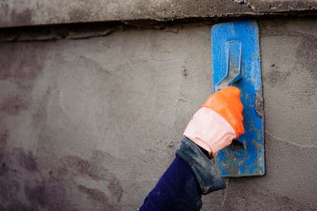 The work of a plasterer by applying plaster to the wall to have a smooth surface.の写真素材