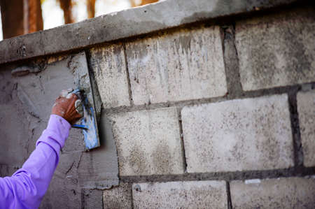 The work of a plasterer by applying plaster to the wall to have a smooth surface.の写真素材