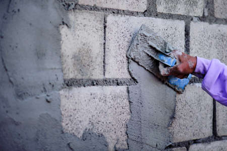 The work of a plasterer by applying plaster to the wall to have a smooth surface.の写真素材