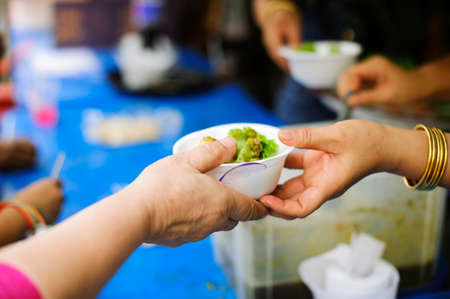 concept of begging food : Beggar begs food from donors: concept of poverty in Asian societyの写真素材