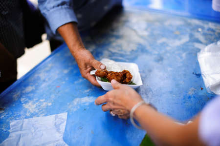 Poor people receive donated food from donors: The hands of the poor receive food from the hands of the humane : the concept of reliefの写真素材