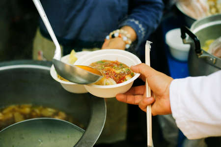 the concept of hope : Hand-feeding to the needy in society : Concept of Feeding : Volunteers give food to the poor : donating food is helping human friends in societyの写真素材