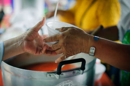 Hunger problems of the poor have been donated food to reduce hunger : the concept of food shortage in the world : Donate Food with Love and Hope to the Poor: The concept of food is essential to lifeの写真素材