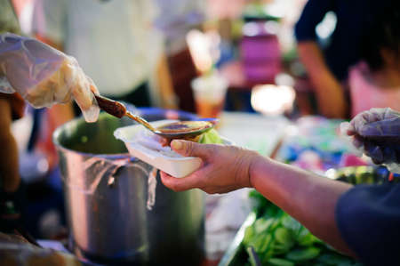 the concept of begging and hunger : Hunger problems of the poor have been donated food to reduce hunger : the concept of food shortage in the world : Donate Food with Love and Hope to the Poorの写真素材