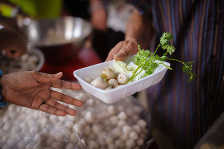 Food needs of the poor in society Help with Food Donation : Homeless people pick up charity food...