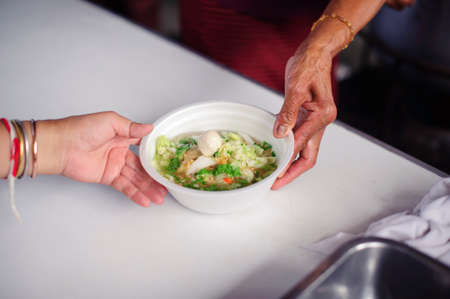 The hands of refugees have been aided by charity food to alleviate hunger : Feeding Concepts : Hand...