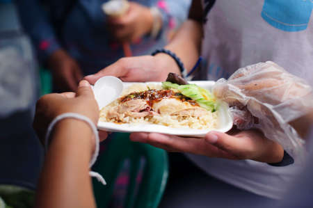 Helping people by donating food: The concept of feedingの写真素材